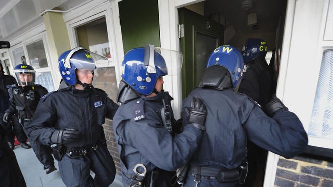 Britain Riots police raid houses